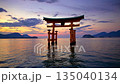 Torii gate standing in the sea at dusk 135040134