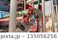 Rolls of gift wrapping paper at gift factory. The packaging is rolled into rolls for wrapping boxes. Gears are used to unroll gift wrapping paper. Process of production and packaging of goods 135056256