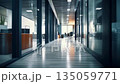 Modern office hallway with reflective tiled floor and warm ambient lighting 135059771