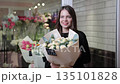 Florist woman holding flower bouquet in shop 135101828
