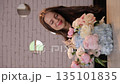 Young happy woman smiling holding beautiful flower bouquet 135101835