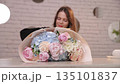 Woman florist creating a beautiful flower bouquet 135101837