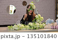 Professional florist woman arranging a bouquet 135101840