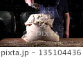 Old Brewer Spreads Malt From a Bag in a Private Brewery Using Super Slow Motion at 1000 Fps 135104436