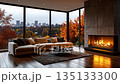 Cozy modern living room with a lit fireplace, large windows, and trees. 135133300