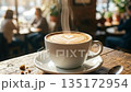 Steaming hot coffee cup with heart latte art on table in cozy cafe. 135172954