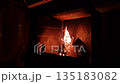 Homeowner Tending To Glowing Fireplace Ambiance, Gentle Actions Of Homeowner Enhancing Cozy Fireside Environment 135183082