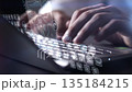 Person typing on laptop with futuristic user interface hologram 135184215