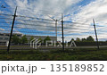 Wind turbine behind metal security fence in an industrial area 135189852