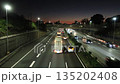 Time lapse of light trails from cars traveling near the Yamato Tunnel on the Tomei Expressway at sunset 135202408