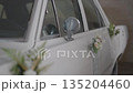 Vintage wedding car decorated with flowers and ribbons. 135204460