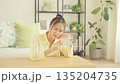 A Japanese woman worried about her smartphone in the living room 135204735