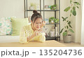 A Japanese woman worried about her smartphone in the living room 135204736