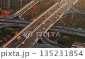 Aerial view of multilevel highway interchange with car and bus traffic in China during the sunset 135231854
