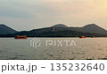 Hangzhou, China - October 6, 2025: Evening cruise on West Lake in Hangzhou, China featuring Leifeng Pagoda and waterfront homes 135232640