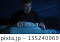 Young man suddenly wakes up in the middle of the night, struggling with insomnia 135240969