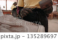 Close up of a craftsman create an intricate stone bas relief using a chisel and mallet. Siem Reap, Cambodia. 135289697