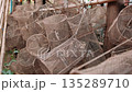 Wire mesh fish traps hanging in a cambodian fishing village. Traditional fishing equipment and gear drying in the open air, Cambodia. 135289710