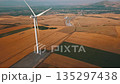 Captivating Aerial View of a Wind Turbine Surrounded by a Beautiful Agricultural Landscape 135297438