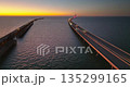Aerial view of Sunshine Skyway Bridge over Tampa Bay in Florida with moving traffic at dusk. Concept of transportation infrastructure 135299165