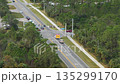 Aerial view of Florida rescue vehicle in motion during emergency call, equipped with active lights and department markings. 135299170