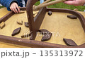 an old wooden game on the outside in which it is necessary transfer chips from your own field to the opponents field 135313972