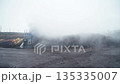 An industrial conveyor system aerator recycles organic waste using rising steam inside a waste processing plant. Depicts recycling technology and environmental engineering. This is an aerobic process 135335007