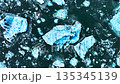Iceberg in the ocean, Huge chunks of blue glacier ice floating on the waves, Arctic nature in Iceland 135345139