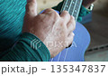 Ukulele, strumming, music. Hands play purple ukulele, close-up. 135347837
