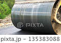 Compactor constructing highway. Steamroller slowly ride. Roadway repair by heavy machinery. Roller laying new asphalt layer. Special machinery making road. Concept of roadwork and motorway maintenance 135383088