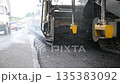 Special machinery making road in countryside area. Compactor constructing highway. Heavy machinery repairing road. Slowly driving roller laying new asphalt layer. Roadwork process. Roadway repair 135383092