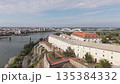 Travel concept. Aerial view of european city with architecture buildings and streets. Petrovaradin Novi Sad fortress along the Danube river. Vertical shot 135384332