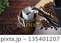 Pour hot water into drip bag coffee 135401207