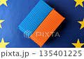 Cargo containers on the EU flag as a conceptual backdrop. Cargo containers on the EU flag 135401225