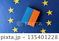 Cargo containers on the EU flag as a conceptual backdrop. Cargo containers on the EU flag 135401228