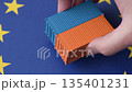 Cargo containers on the EU flag as a conceptual backdrop. Cargo containers on the EU flag 135401231