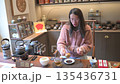 Woman Engaging In Tea Ceremony With Teacups 135436731
