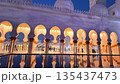 The Sheikh Zayed Grand Mosque is illuminated against blue twilight sky, showcasing its white marble domes and reflective pools in Abu Dhabi, UAE 135437473