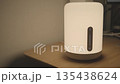 Smart lamp turning on while standing on a table, modern smart home lighting. 135438624