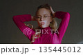 Close-up 4K footage of a sensual young beautiful Caucasian blonde woman with eyeglasses fixing her hair. Young blonde woman with glasses gently fixes her hair, exuding calm elegance and charm. 135445012
