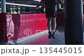 The silhouette of a male boxer during a jumping rope workout in a dark boxing gym. Silhouette of a man boxer skipping rope, building stamina in low light. Slow motion zoom out 4K footage. 135445015