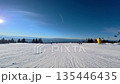 Beautiful POV ski landscape on the mountains. Skier skis down a snowy mountain trail in sunny weather. 135446435