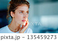 Young woman touching her cheek in pain, illustrating toothache, dental problems, and oral health issues 135459273