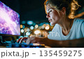 Young woman intensely working at a computer with abstract neural network visuals on screen, representing artificial intelligence, data science, and innovation 135459275