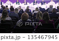 Attendees engage actively, Conference participants exchange insights amidst dynamic discussion 135467945