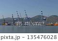View of Novorossiysk port Russia with cargo ships and cranes on the coastline. Industrial maritime scene on the Black Sea. 135476028