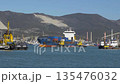 View of Novorossiysk port Russia with cargo ships and cranes on the coastline. Industrial maritime scene on the Black Sea. 135476032