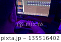 A musician plays a synthesizer and records a melody on a computer. 135516402