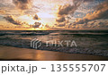Dramatic sea sunrise or sunset sky over sea. Burning sky and shining golden waves landscape,Beautiful waves crashing on sandy shore 135555707