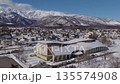 Kyowa Wing Hakuba (Wing 21) and the Hakuba mountain range, with snow rising from it. Hakuba Village, Nagano Prefecture (aerial photo taken by drone) 135574908